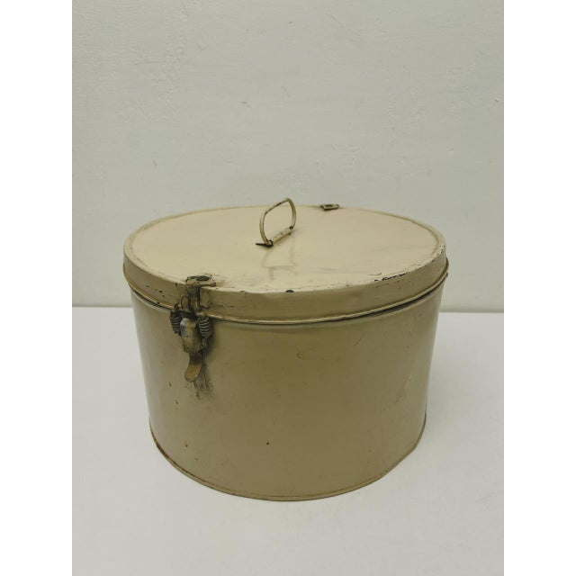 Antique and authentic cream (yellowed) painted metal hat box from the 1920s. A beautiful decorative object with unusual...