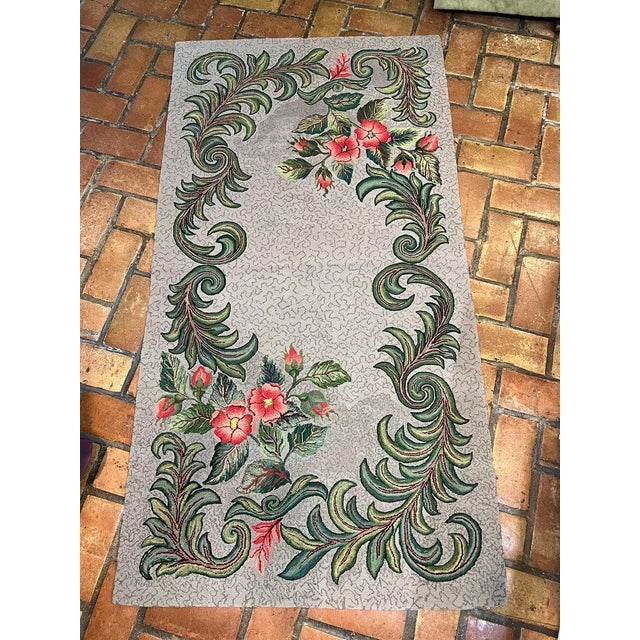 Colorful signed and dated hooked rug . Pretty floral accents . Background is a gray tone with red and green bold florals ....
