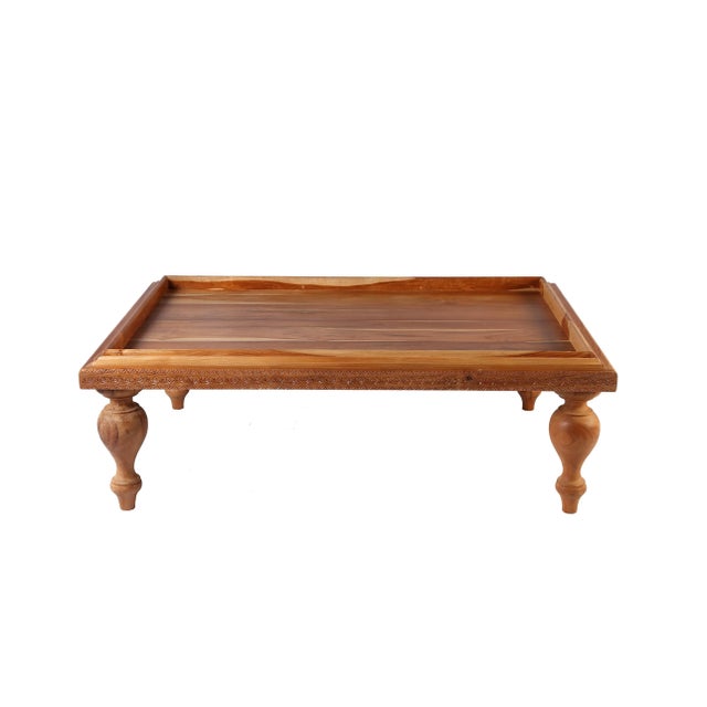Bulb shape legs, Bali fork art carved sides, this tray coffee table adds exotic flavor to a living room. Handcrafted...