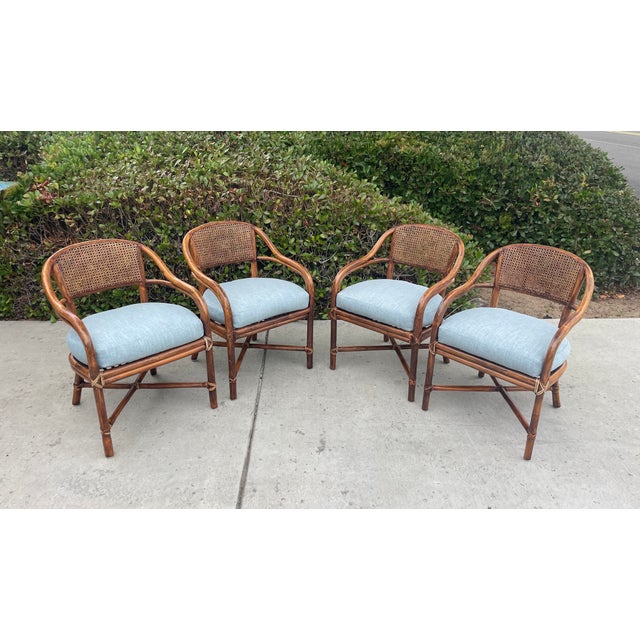 Beautiful vintage set of 4 authentic McGuire rattan armchairs, dining chairs or accent chairs. These chairs feature a...