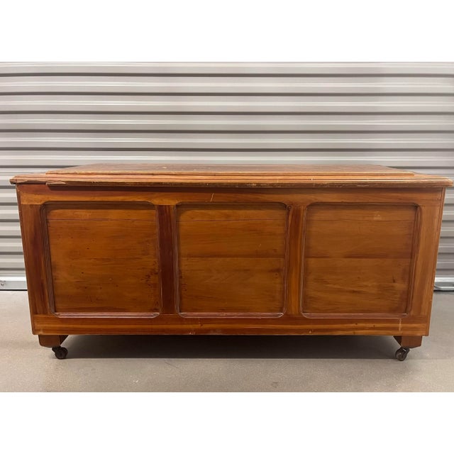 Large vintage wood trunk or chest on wheels with handles on sides and two interior sliding storage trays. Beautiful wood...