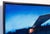 Station Blue depicts a desolate gas station under a deep blue twilight sky, evoking a sense of isolation and stillness....