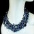 This elegant three-strand necklace showcases the natural beauty and unique character of genuine Peacock Keshi pearls. The...
