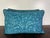 This elegant pair of pillows showcases a luxurious design in a rich teal blue hue. The front features a botanical and...