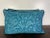 This elegant pair of pillows showcases a luxurious design in a rich teal blue hue. The front features a botanical and...