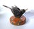 New. Original, contemporary folk art from Mikel Davison. A rustic, wooden little black bird on a daisy-flowered base....