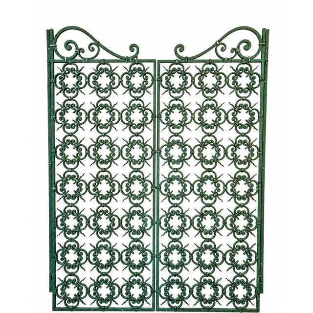 Pair of 1950s wrought iron interior grilles. This model, of very high quality craftsmanship, is in its original green...