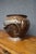 Japanese bronze jardinière featuring a rounded body, raised circular foot, and flared rim. The exterior is decorated with...
