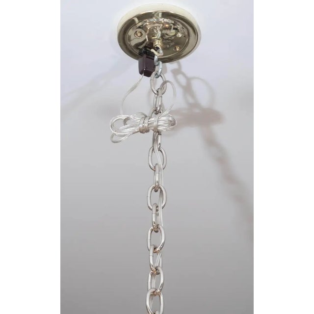 An elegant, yet whimsical six-light chandelier attributed to Sciolari. The piece features a centre arm surrounded by a...