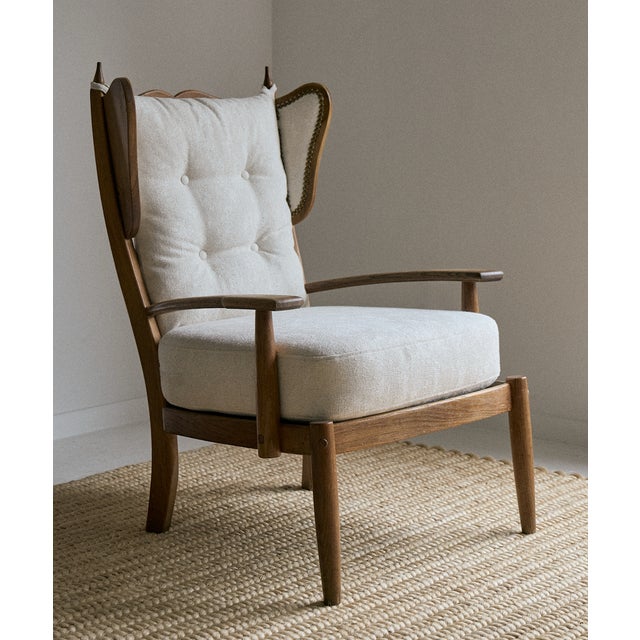 Pair of 1940s/50s oak and upholstered armchairs, France. These unique French lounge chairs have been newly reupholstered...