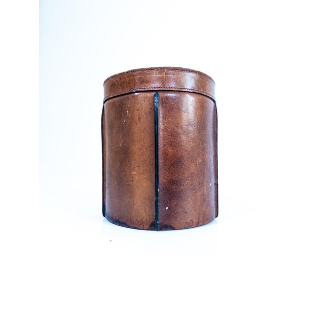 A refined waste bin crafted in richly patinated cognac-colored leather, produced in France during the 1960s. The...