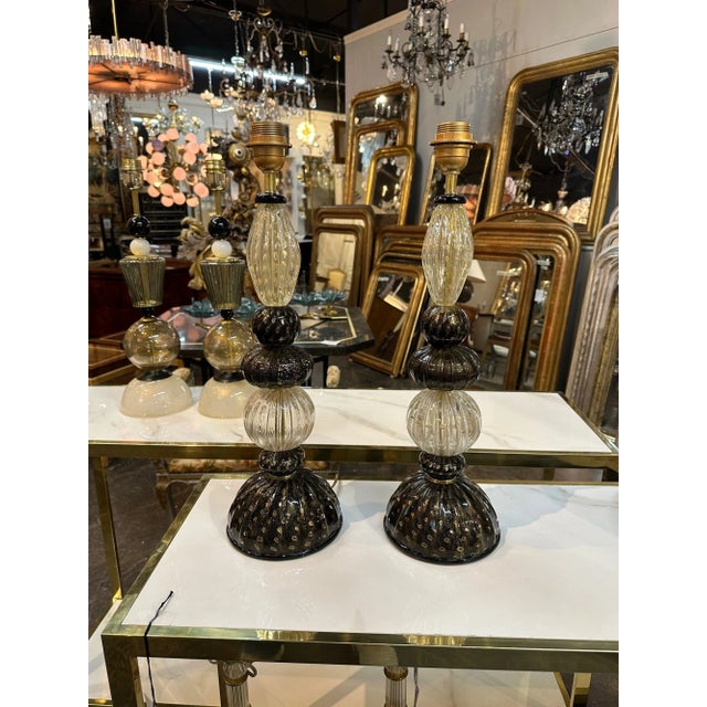 Handsome pair of modern black and gold Murano glass lamps. A beautiful decorative element for a fabulous home!