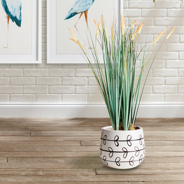 A repeated vine pattern adorn this set of pots. They are just the perfect vessels for lush greens or a tailored orchid....