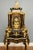 Exceptional French Boulle style mantel clock raised on its original matching console stand The clock is richly decorated...