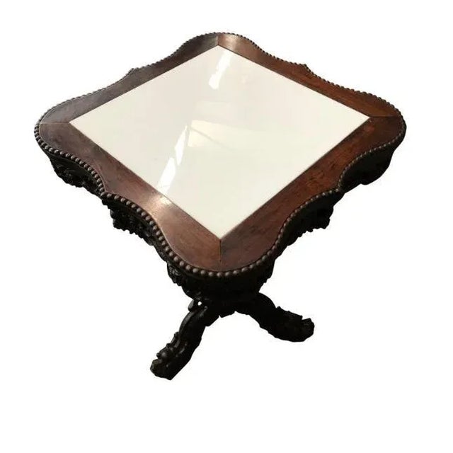 A square 19th century chinese carved hardwood center table with marble top. Inset white marble top with decorative base....