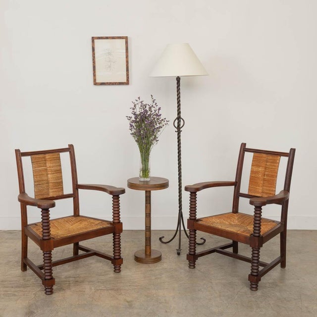 Incredible pair of carved wood armchairs by Charles Dudouyt from France, 1940s. Beautiful woven rush back and seat....