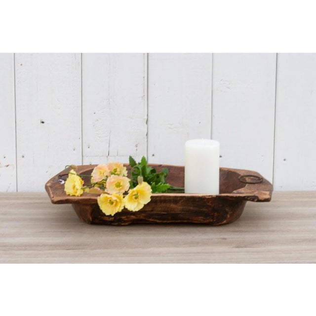 An old oval shape wood bowl originally used for kneading dough. Found in the Swat Valley. This antique dough bowl was made...