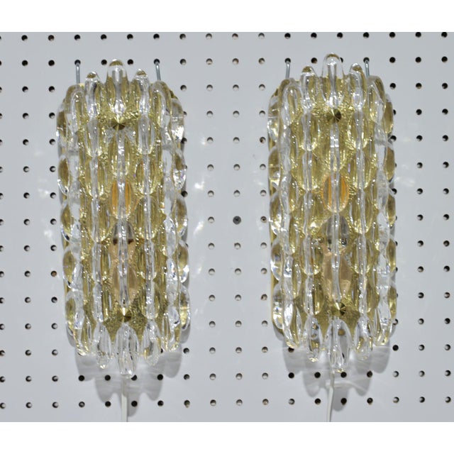 Elevate your home décor with a pair of thick crystal bubble lamps designed by Karl Fagerland for Orrefors, 1950s. These...