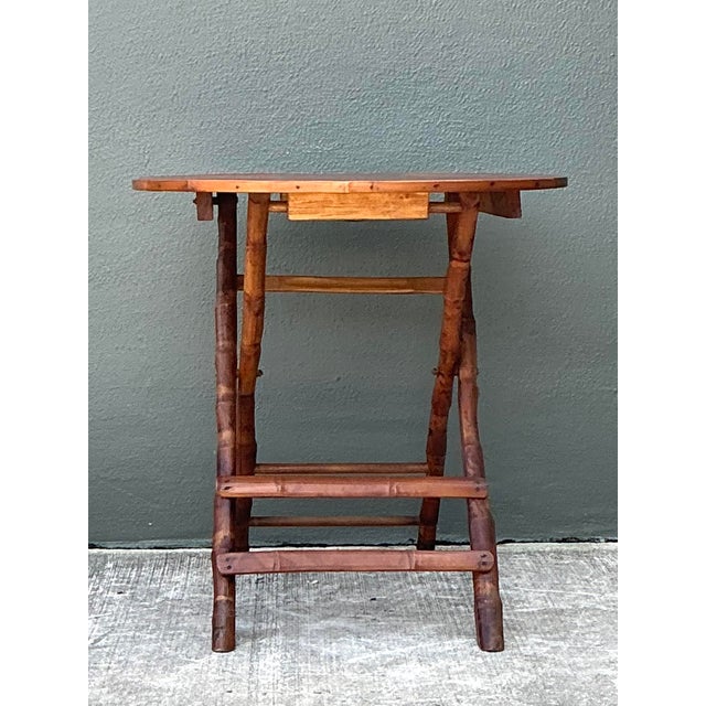 This charming vintage folding table is a masterclass in organic texture and functional design, perfect for bringing a...