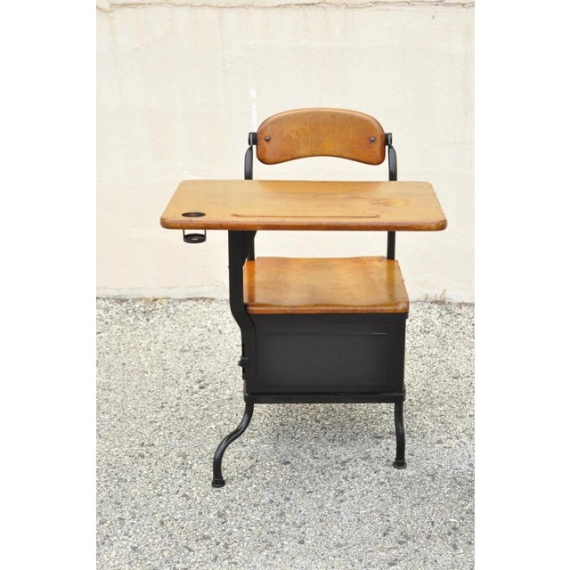 Antique American Industrial Iron and Maple Childs School Writing Desk. Item features a lower cubby storage to side, iron...