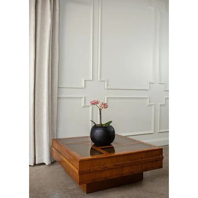 This striking 1970s coffee table is a true conversation piece, featuring a monumental square form with smoked glass panels...