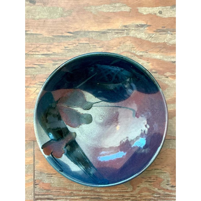 This striking vintage studio pottery bowl is a vibrant celebration of organic form and abstract expressionism, reflecting...