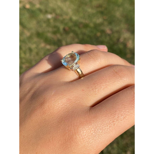 The 102nd Avenue: Aquamarine and Natural Diamond Ring in Yellow Gold. Behold the captivating beauty of this ring,...