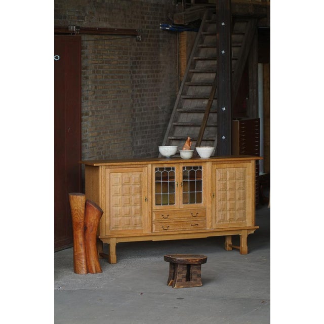 A beautiful danish sideboard crafted in solid oak during the 1960s, designed by henning kjærnulf. The cabinet combines...