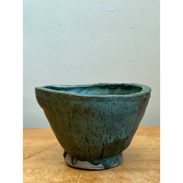 This vintage abstract pottery bowl brings sculptural character to a room through its organic, asymmetrical form and deep...