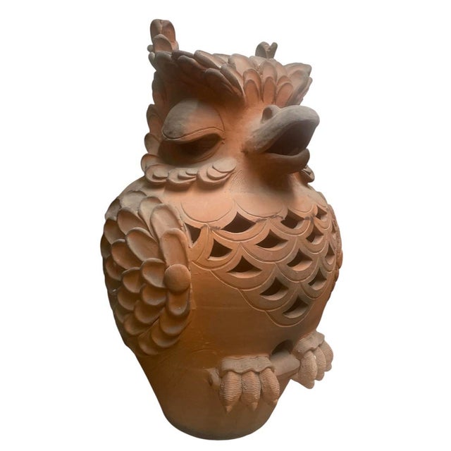 A captivating and highly decorative pair of vintage terracotta garden lanterns sculpted in the form of stylized owls....