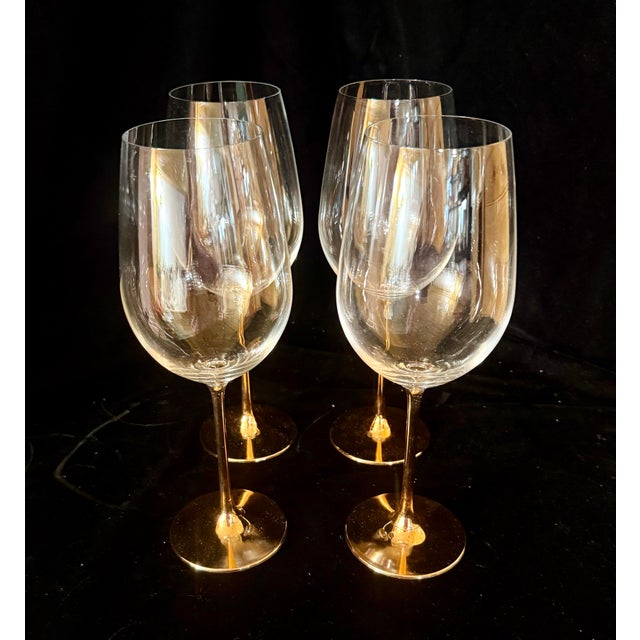 This set of four elegant large wine glasses feature clear, generous bowls paired with striking, reflective metallic...