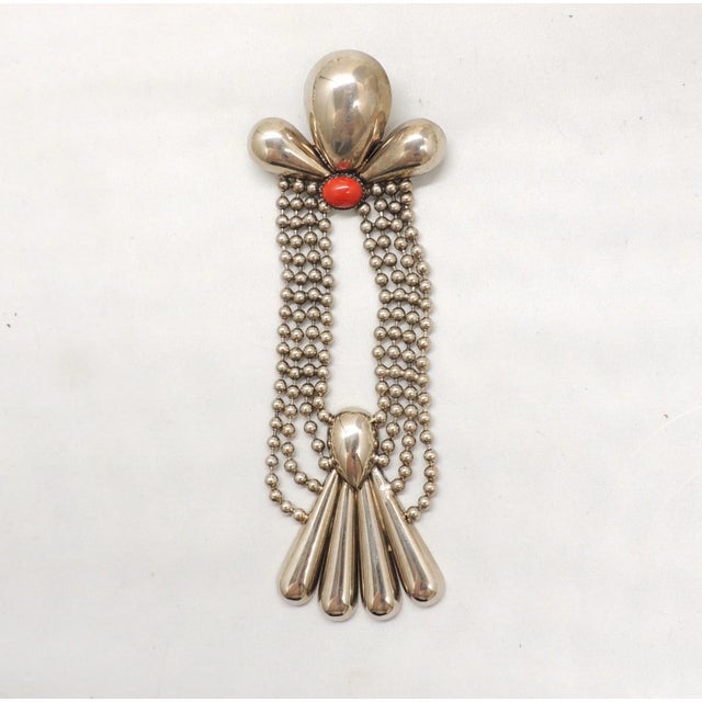 This is part of Chairish’s Costume Jewelry assortment. 1980s Deco style silvertone cabochon faux-carnelian long brooch...