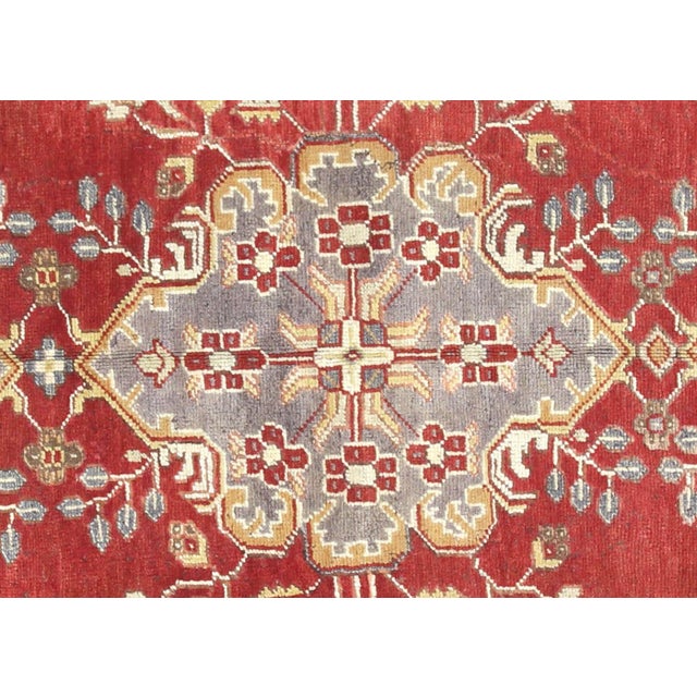 A vintage Turkish Oushak measuring 4'8" x 11'7", hand-woven with wool on wool foundation. This piece displays the region's...