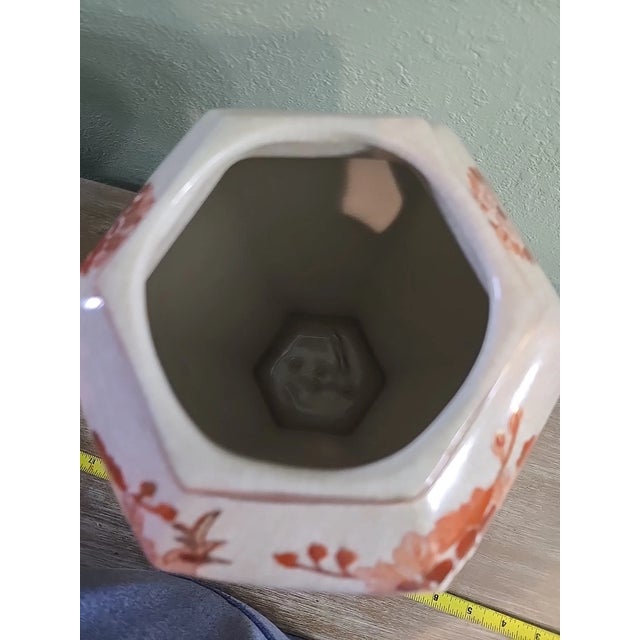 Striking and richly detailed, this large antique Japanese Kutani vase showcases the vibrant artistry the Kutani tradition...