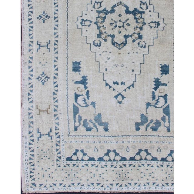 Faded vintage Turkish Oushak rug with Central Medallion in cream and blue, rug Keivan Woven Arts country of origin / type:...