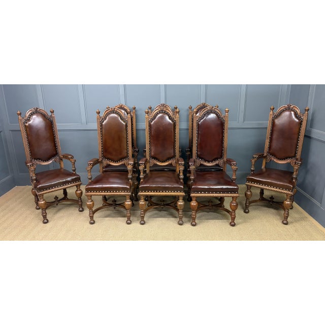 A splendid set of 8 carved oak high back armchairs. Of very good construction in solid oak, with crisply carved...