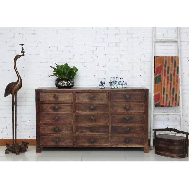 This fifteen drawers sideboard was made in 19th century from GanSu China. Its multiple drawers offer spacious room for...