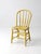 Antique Windsor spindle-back chair with a charming yellow-painted finish and classic bow-back form. Five slender spindles...