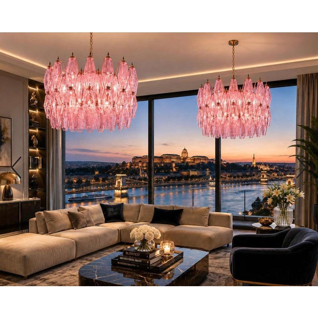 Chandelier featuring a circular metal frame with a gold finish, suspended from a matching chain. The light fixture is...