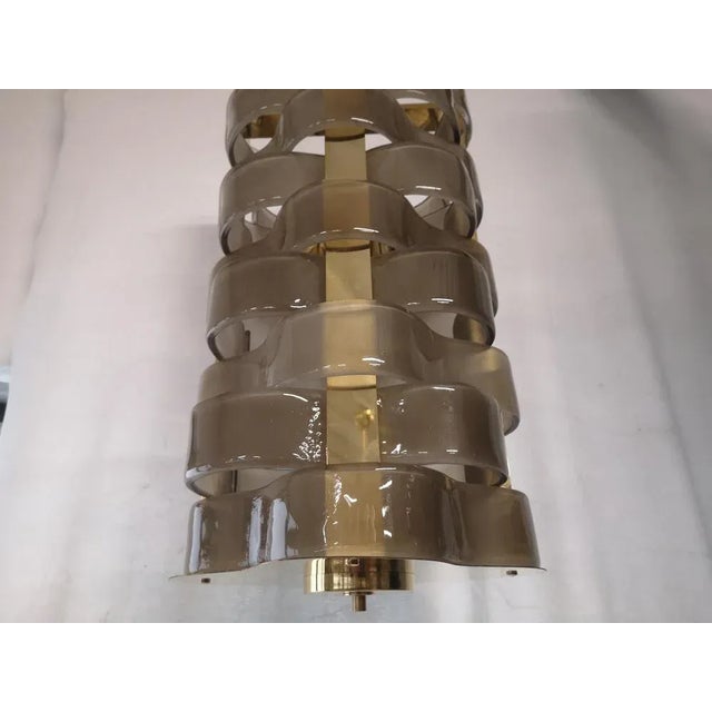 Design in woven Murano glass for this smoky colored chandelier, its style is elegant and linear. The chandelier is in...