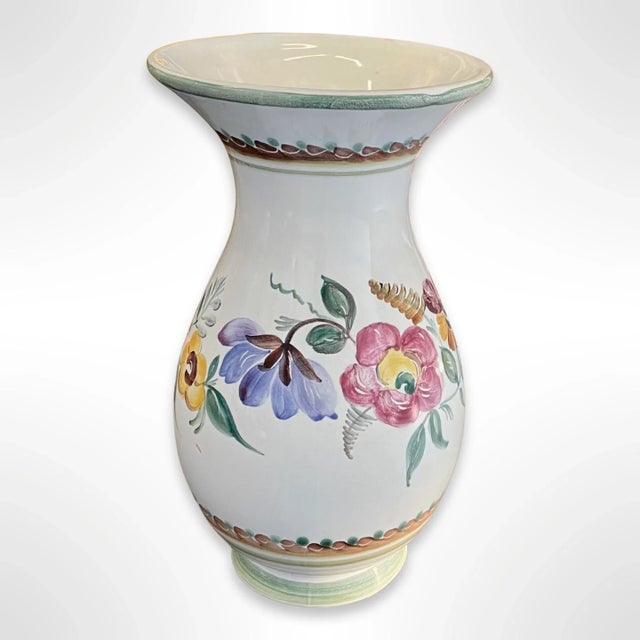 A stunning vintage Austrian Keramik ceramic vase. The vessel is white with hand-painted colorful flowers. The makers mark...