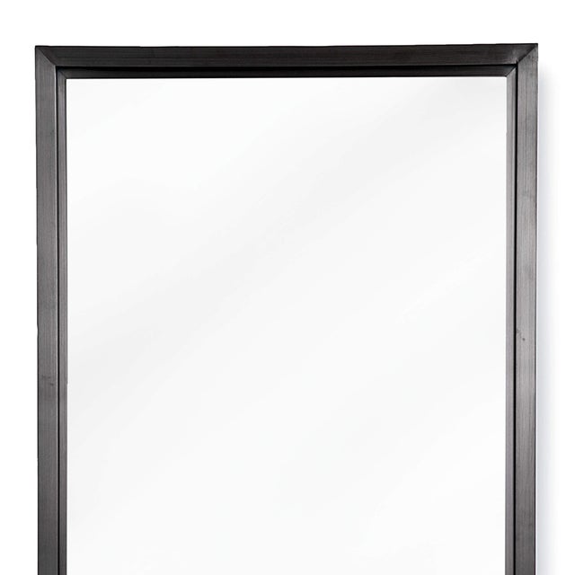 With its subtle blackened steel frame and minimalist design, this rectangle mirror adds a finished touch to any room.