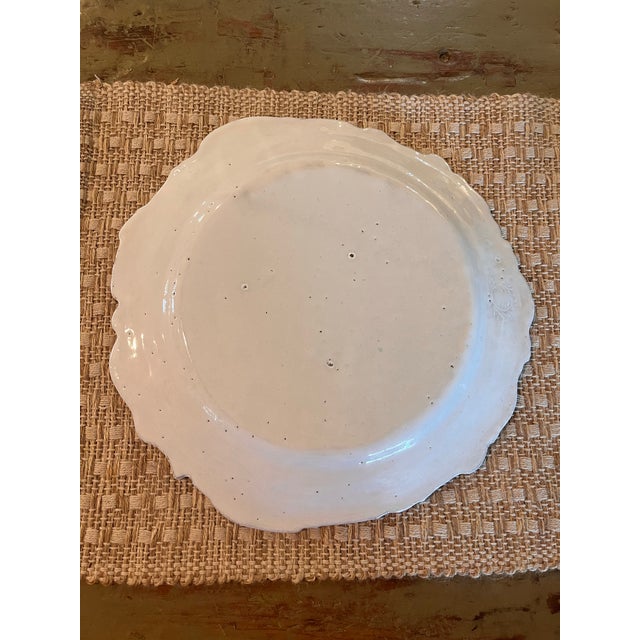 Elegant handcrafted ceramic charger by celebrated Parisian atelier Astier de Villatte. Measuring an impressive 12.5 inches...