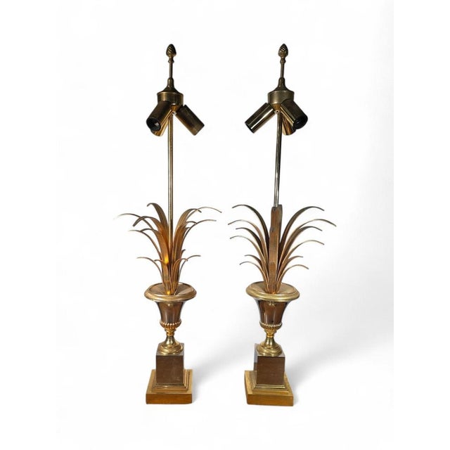 An elegant pair of table lamps by Maison Jansen, crafted in gilded brass and designed in the iconic pineapple motif. These...
