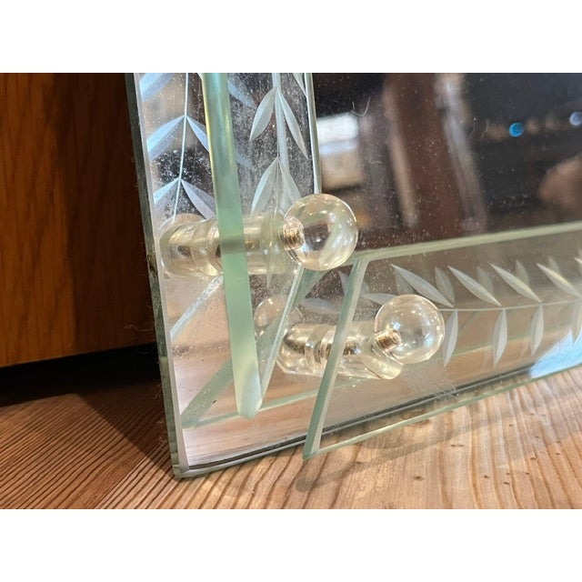 Elegant mirrored vanity tray or serving tray with raised beveled glass borders. The glass borders have reverse etched...
