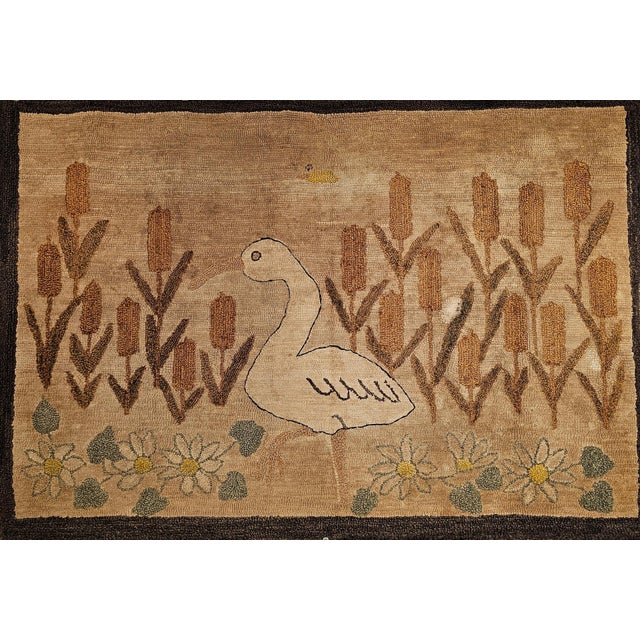 32” x 47” Early 20th Century hand hooked rug in a wonderful bird and flowers design in earth tone color pattern. The rug...