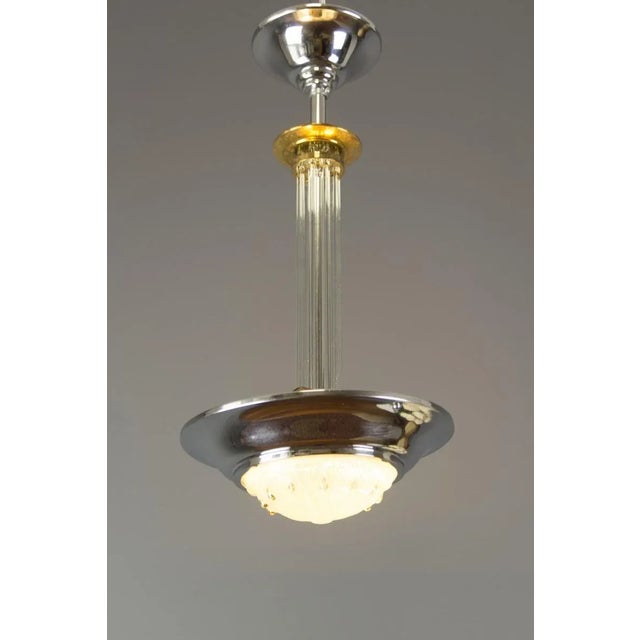 - French Art Deco chandelier/pendant light; - Chromed brass frame with Ezan style relief glass dome; - Glass rods center....