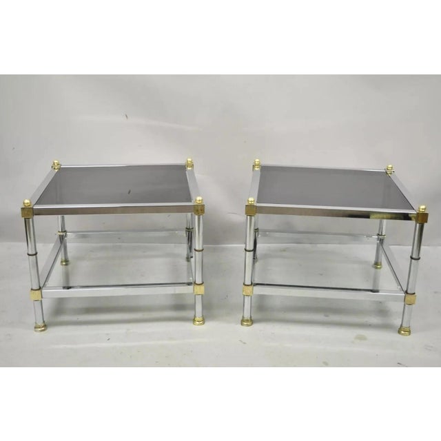 Vintage Hollywood Regency Maison Jansen Style Chrome & Brass Square End Tables - a Pair. Item features smoked glass tops,...