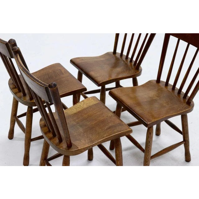 Set of 4 brutalist solid oak dining chairs from the 1960s. The chairs are packed with subtle details which reveal true...