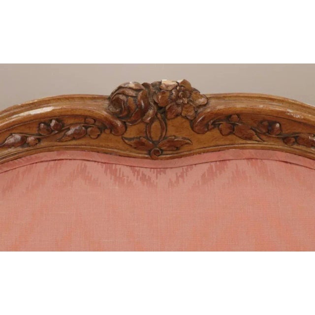 A charming French Provincial Louis XV Style Cherrywood Settee upholstered in dusty rose silk brocade. Raised by elegant...